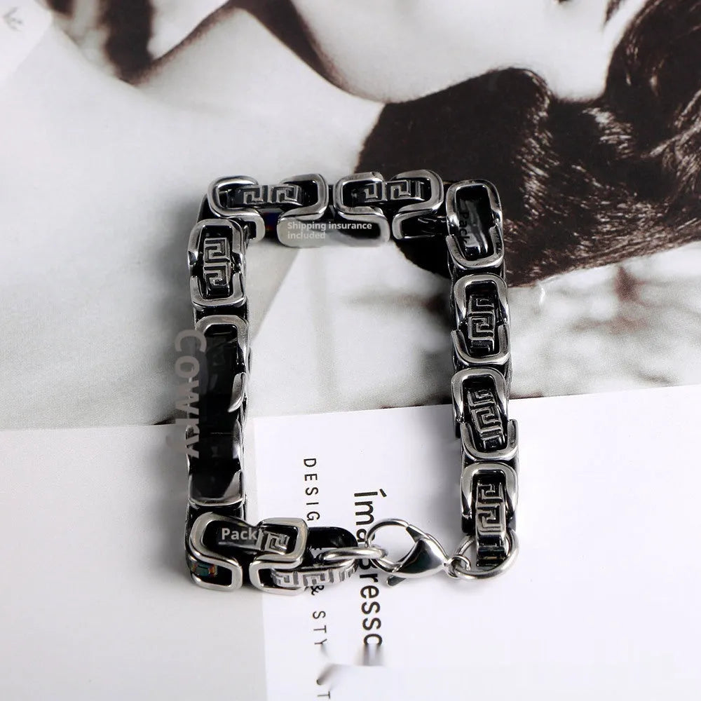 Retro black polished stainless steel geometric chain bracelet on a neutral surface
