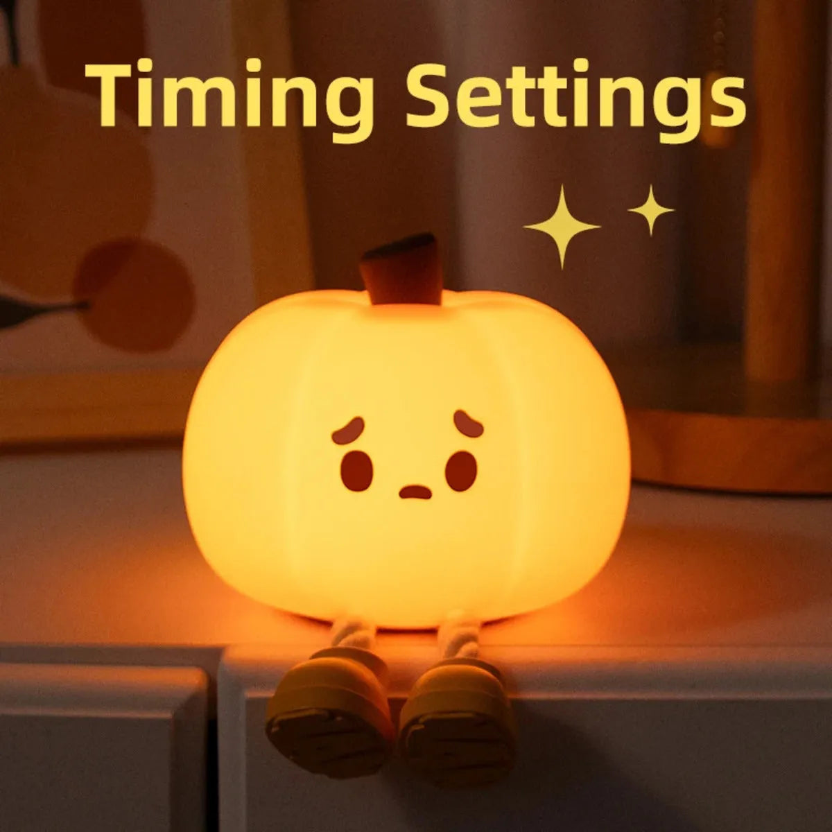 Pumpkin-shaped silicone night light with rechargeable battery on a bedside table