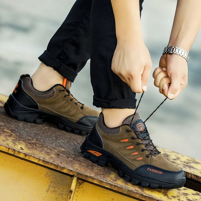 Men's suede hiking shoes with rubber sole in green colour showing mid-top design and lace-up closure
