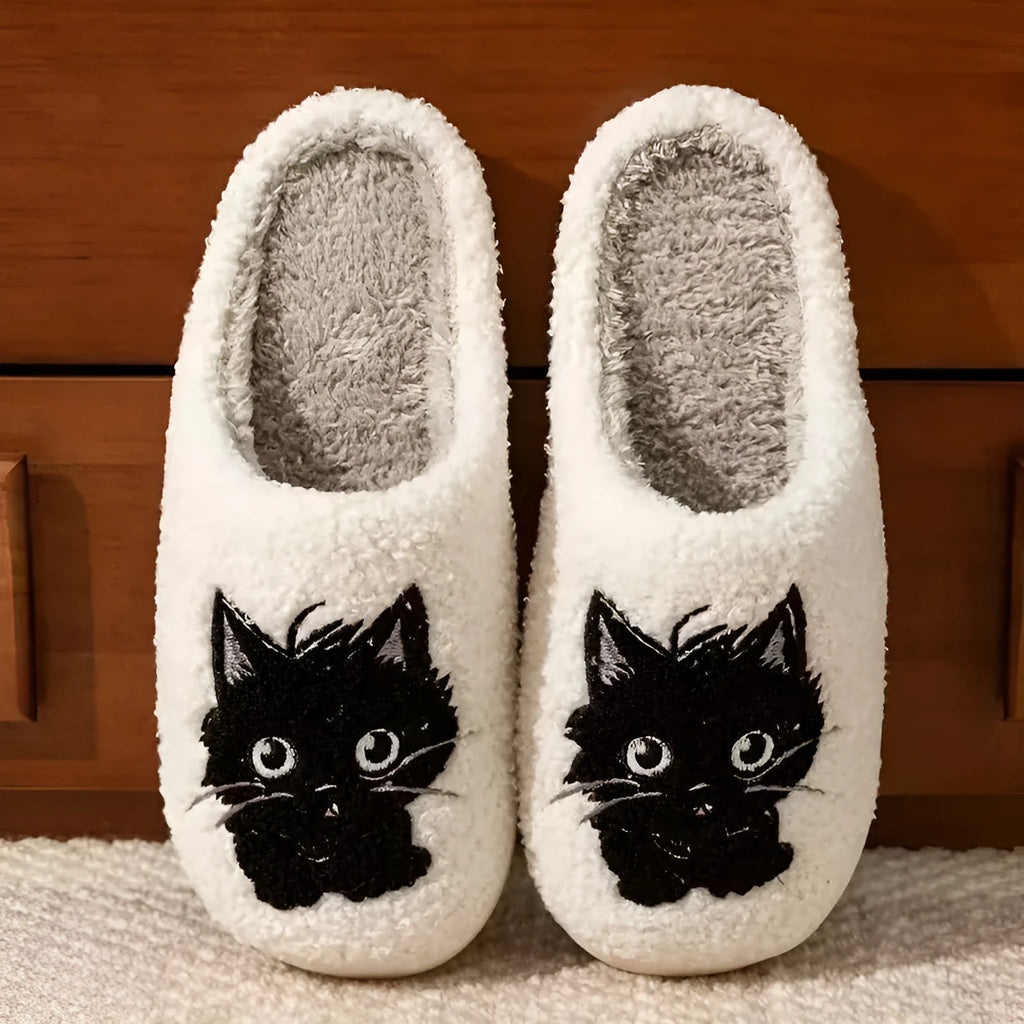 White plush slippers with a Black Beard Cat cartoon design on the toe.
