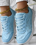 Women's white canvas running shoes with a round toe, flat heel, and soft sole on a neutral background.