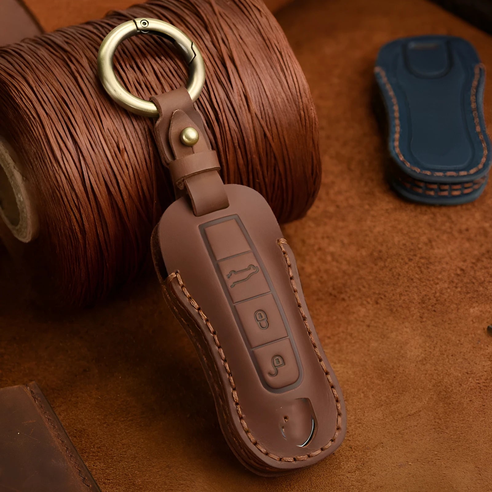 Porsche leather key cover with retro bag buckle in blue and brown colour options