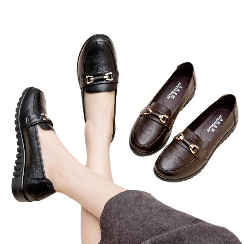 Black soft leather women's loafers with round toe and low flat heel on a rubber sole.