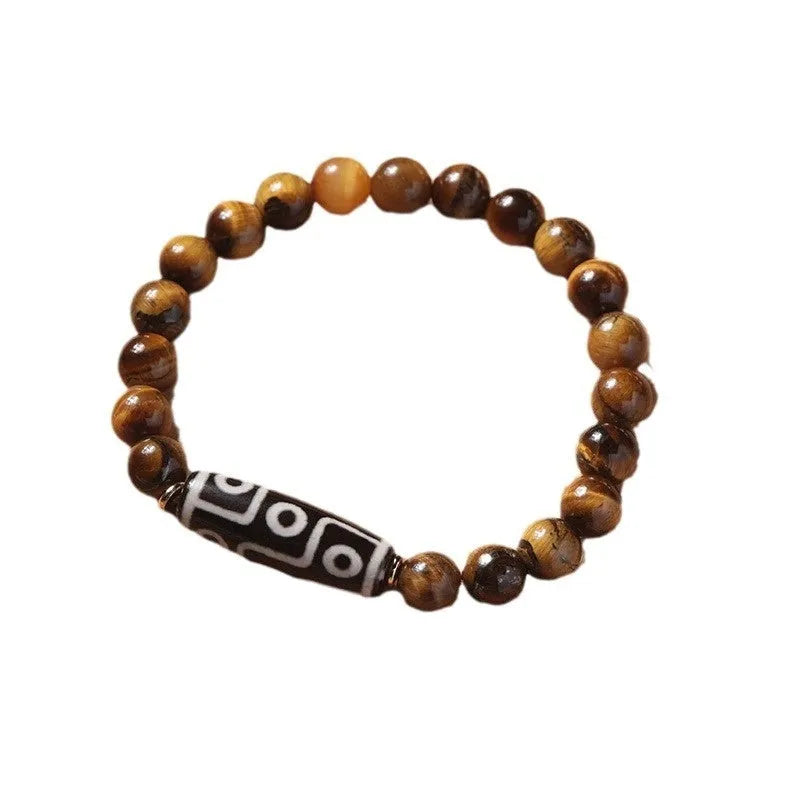 Single strand tigereye Buddha bead bracelet with dzi pattern on wrist, showing 10mm bead size.