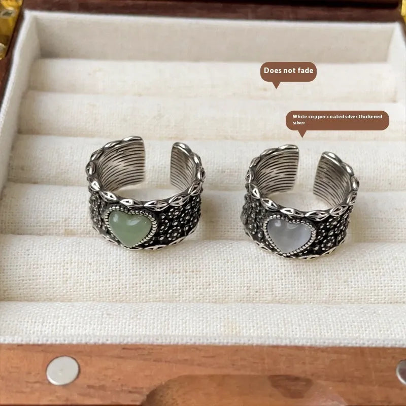 Retro-style adjustable silver heart ring shown in white and green colour options.