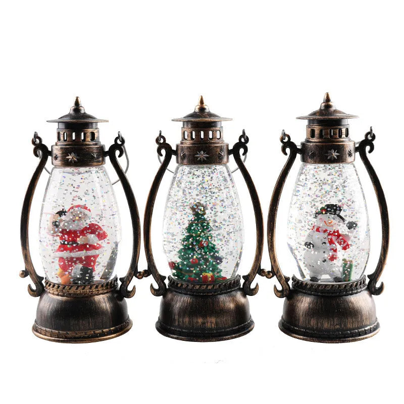 Plastic crystal ball LED oil lamp Christmas decoration showing internal snowman scene on a desktop.