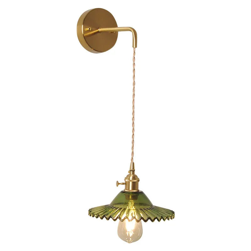 Retro brass lotus wall lamp with glass shade mounted on a wall, showing copper fittings.