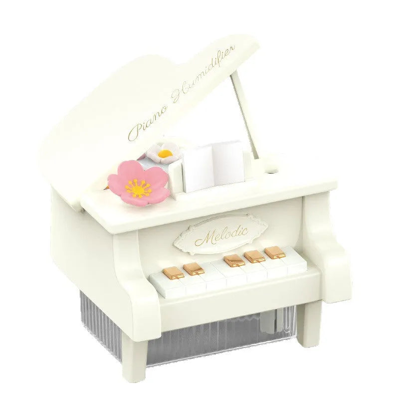 Small square plastic ultrasonic aroma diffuser on a desk with USB cable and black colour option