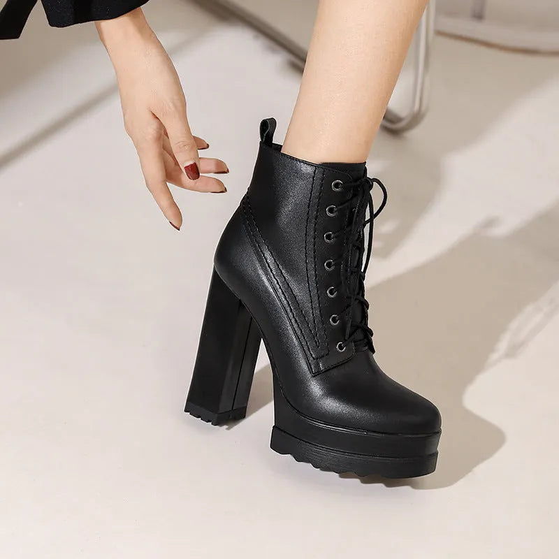 Women's black chunky heel waterproof platform ankle boots with side zip on a white background