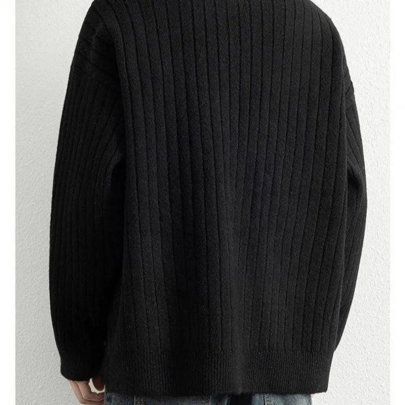A grey men's textured knit half-zip sweater with a loose fit and long sleeves on a mannequin.