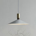 Minimalist round single-headed iron pendant lamp in black, shown in a dining setting.