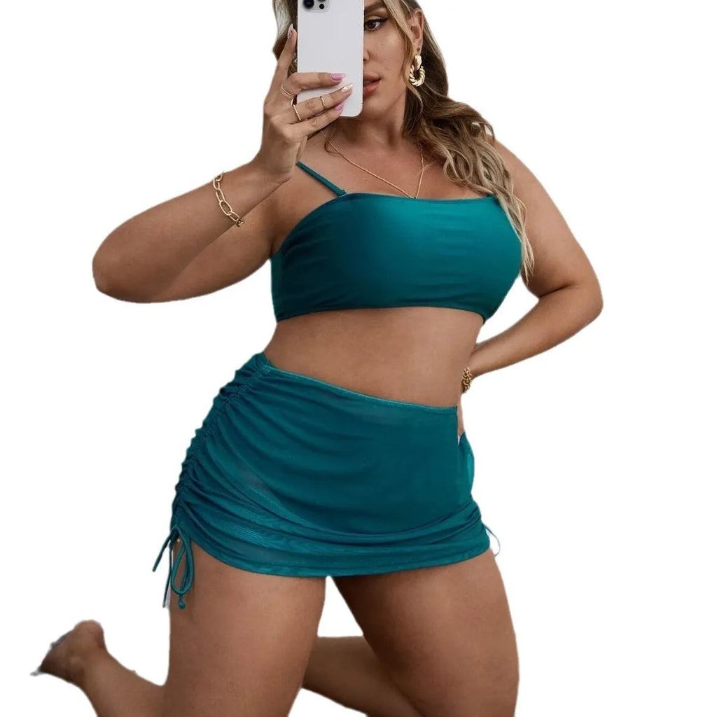 Women's solid colour mesh bikini three-piece set with apron on a mannequin.