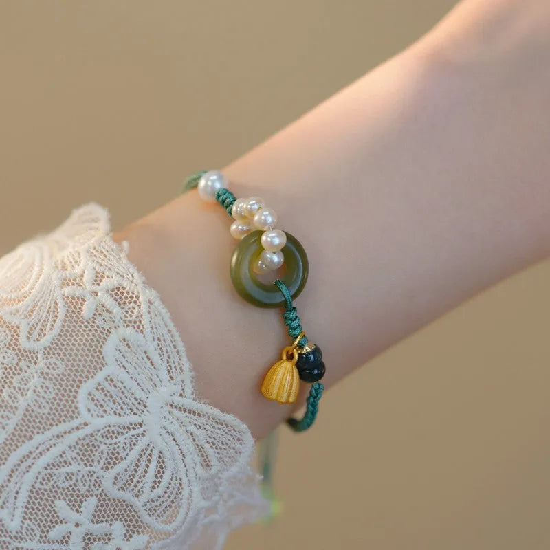 Hand-woven DIY watch band with flexible wire and a round pearl peace buckle closure.