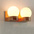 Solid wood spherical wall lamp with glass shade on a living room wall, single head