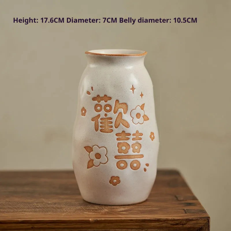 Chinese hand-painted ceramic vase with carved design on wooden desk