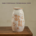 Chinese hand-painted ceramic vase with carved design on wooden desk