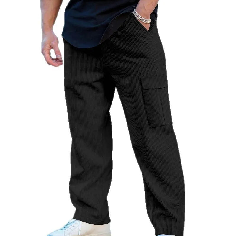 Men's navy blue corduroy cargo trousers with a drawstring waist and wide straight legs laid flat.