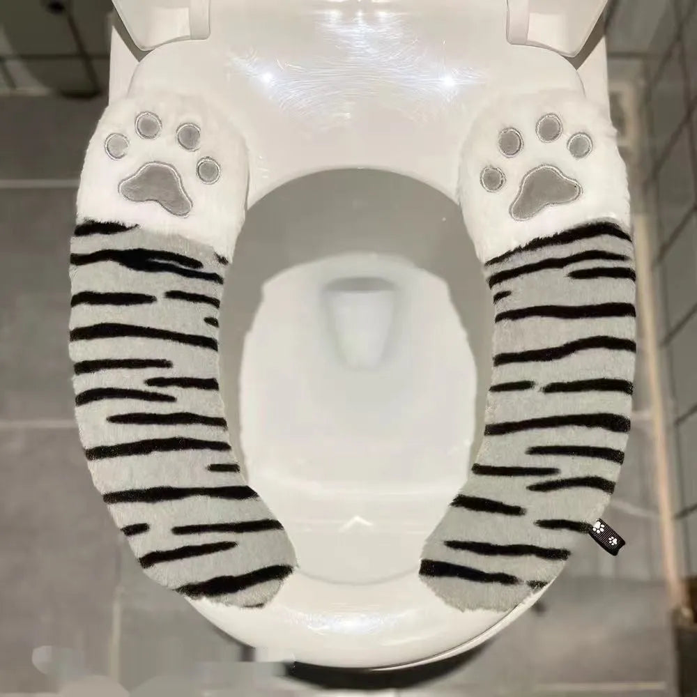 Plush toilet seat cushion with adhesive Velcro fastener in black and white stripes for bathroom use