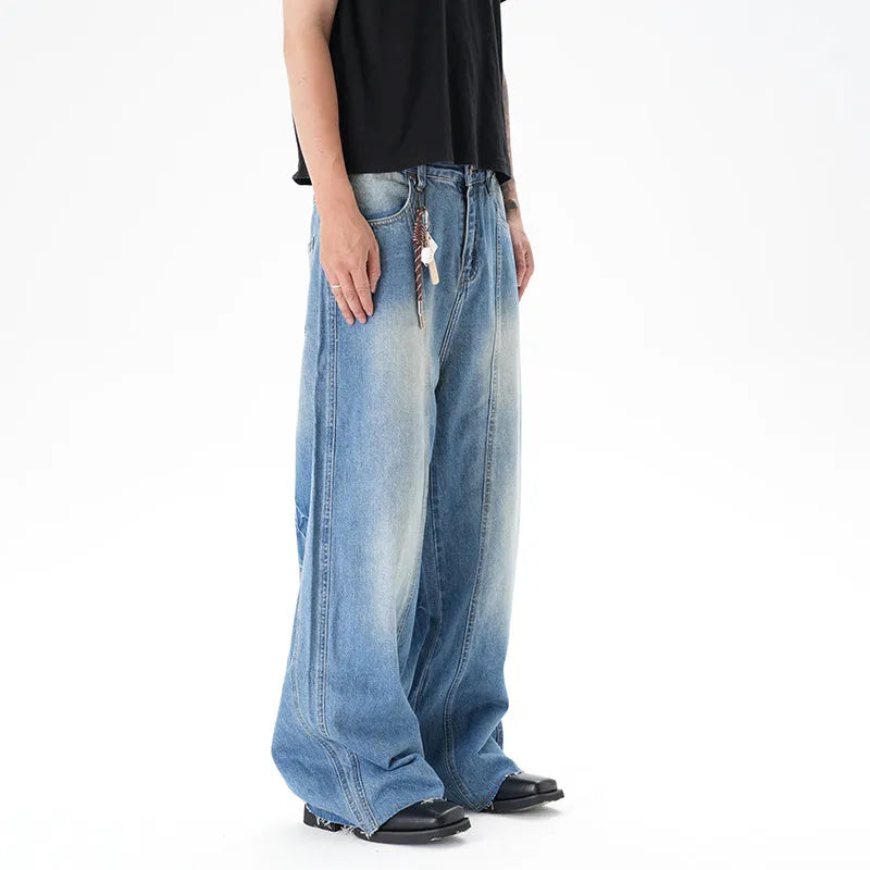Cut washed vintage washed wide leg machete jeans in light blue denim fabric with zip fly