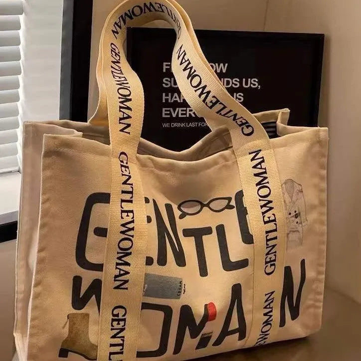 Large women's canvas tote bag with printed design, shown in available colour options.