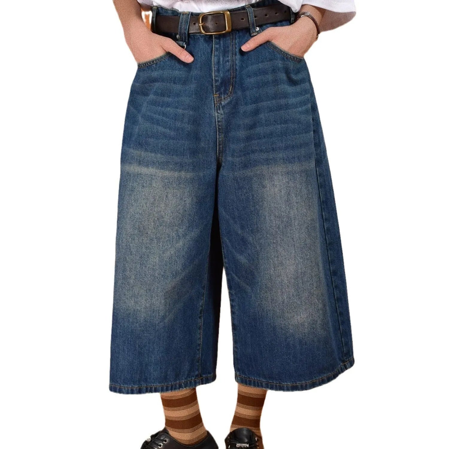 Men's loose straight-leg denim shorts in a light blue wash, showing fifth-pant length and relaxed fit.