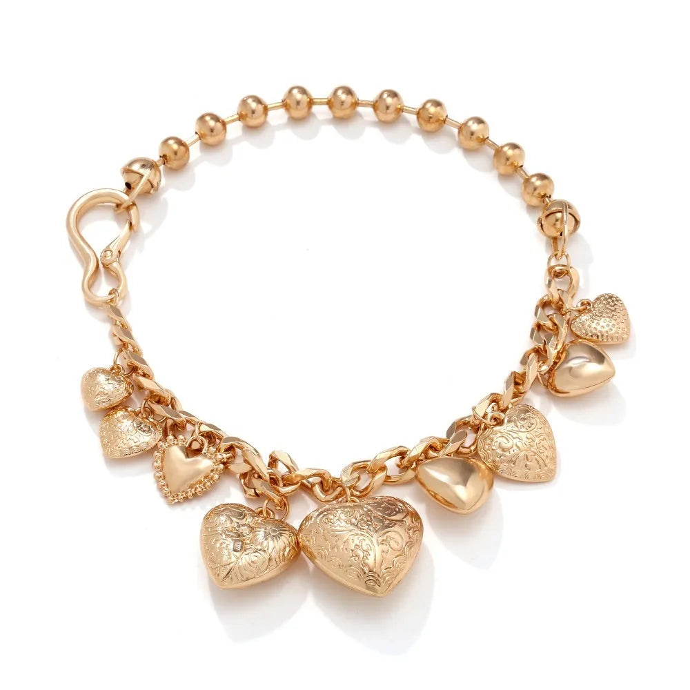Gold carved heart pendant necklace on an adjustable metal chain.