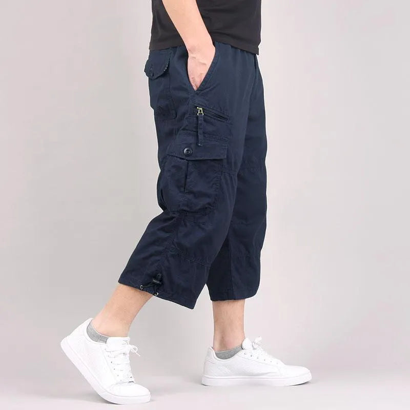 Man modelling loose-fitting khaki cotton cropped casual pants.