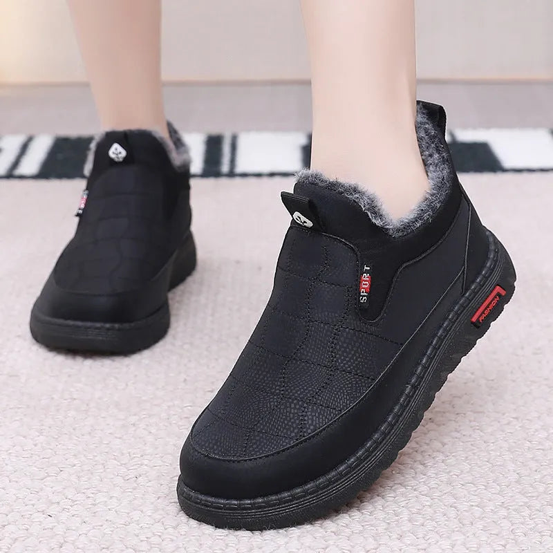 Women's black casual flat boots with a round toe and low-top synthetic leather upper.