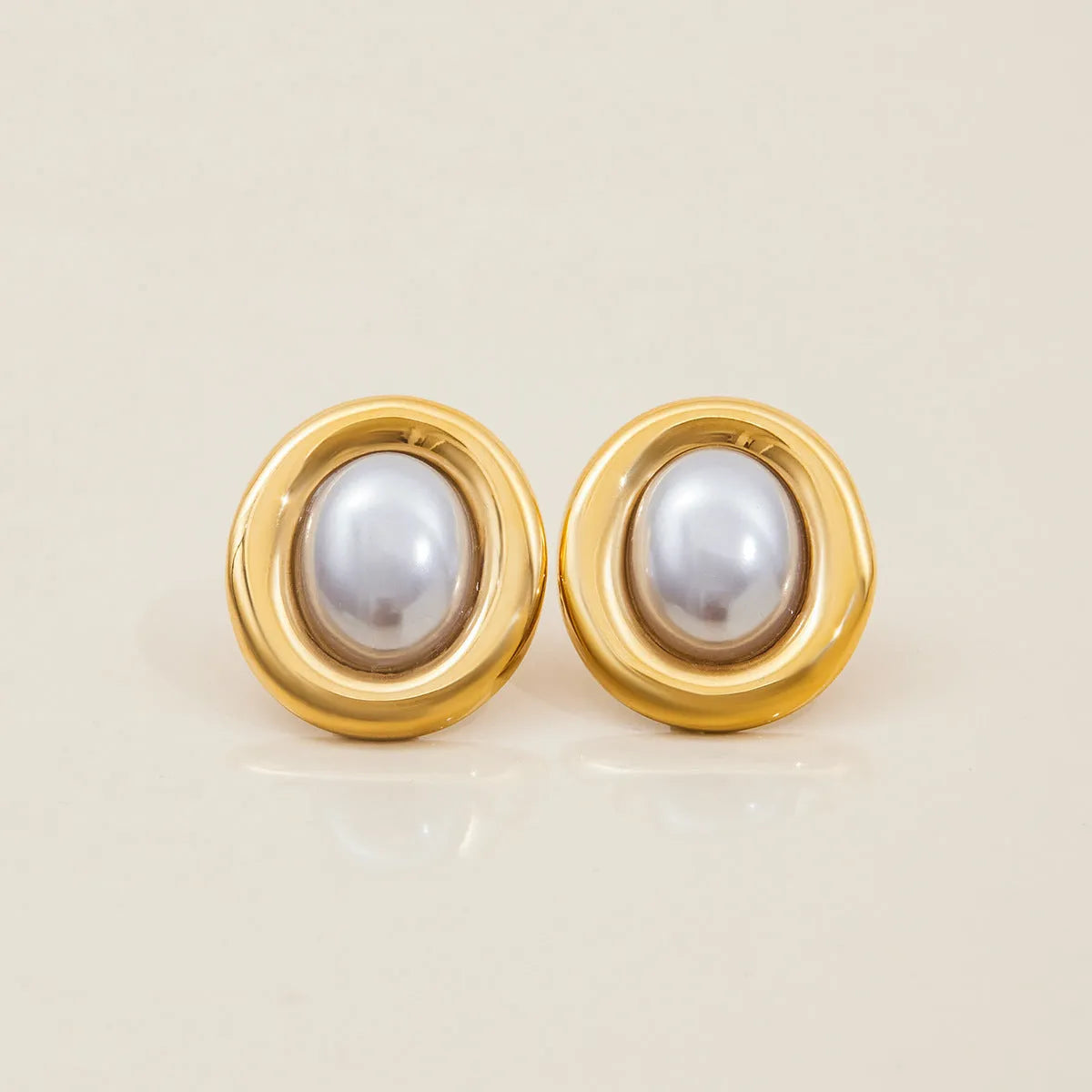 Close-up of women's stainless steel vintage pearl stud earrings with a 10mm white pearl.