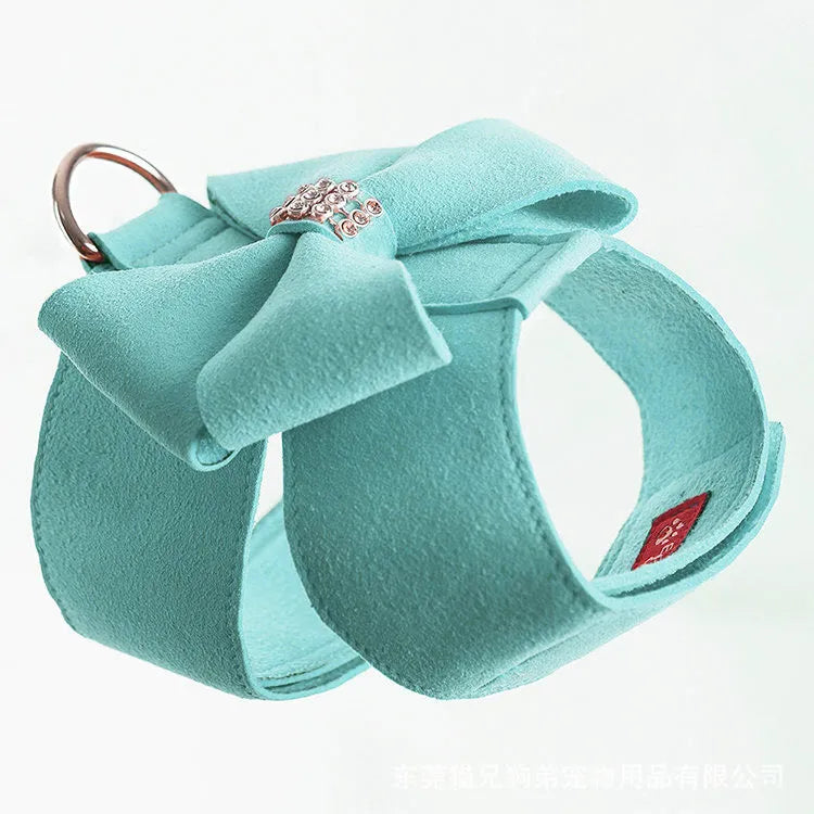 A pink microfiber dog harness with a decorative bowknot on the collar, sized for a small puppy.