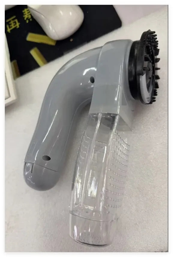 Grey portable electric pet hair remover vacuum with soft rubber grooming head for dogs and cats.