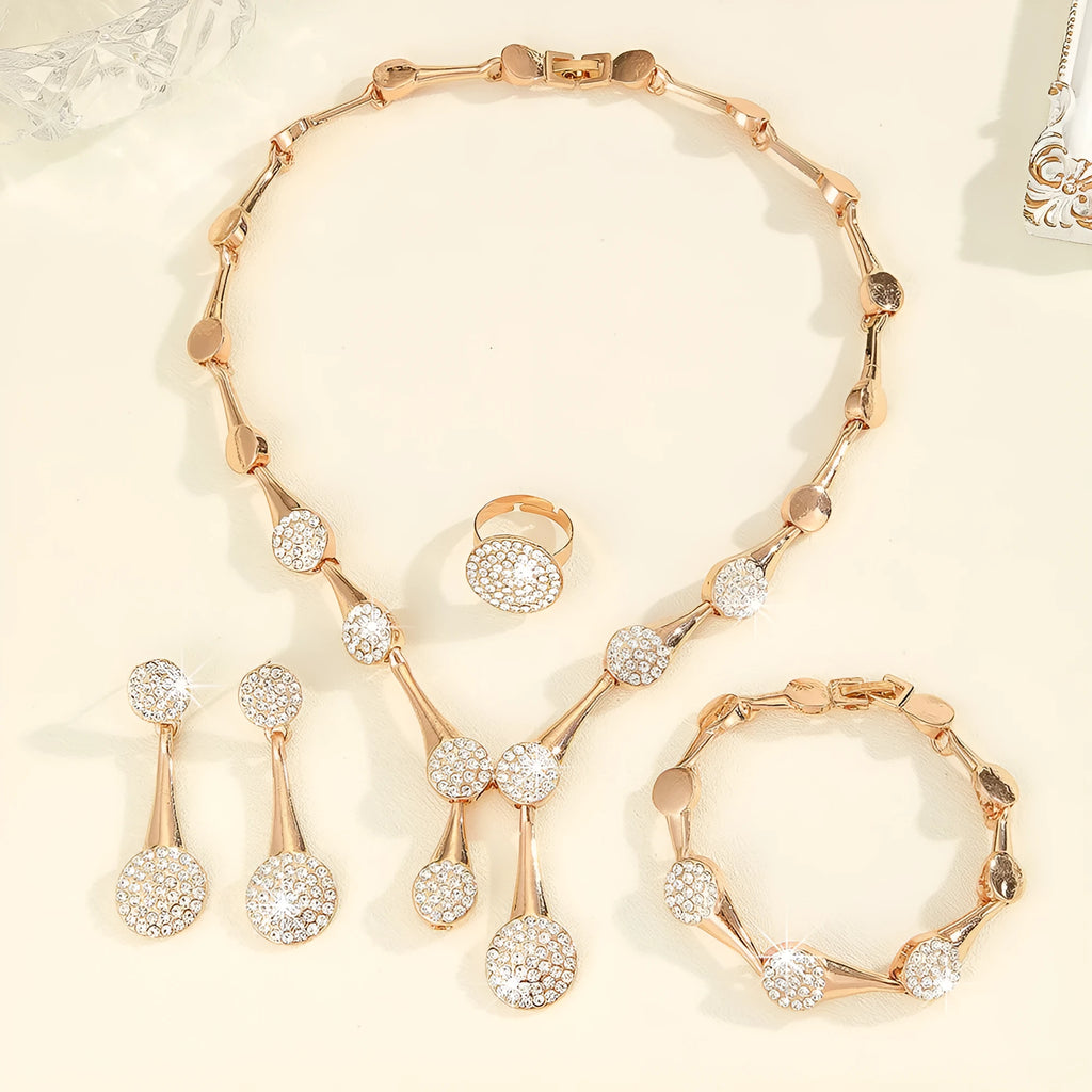 Gold alloy necklace earrings and bracelet set with bow and fan motifs on a light background