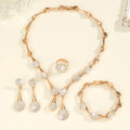 Gold alloy necklace earrings and bracelet set with bow and fan motifs on a light background