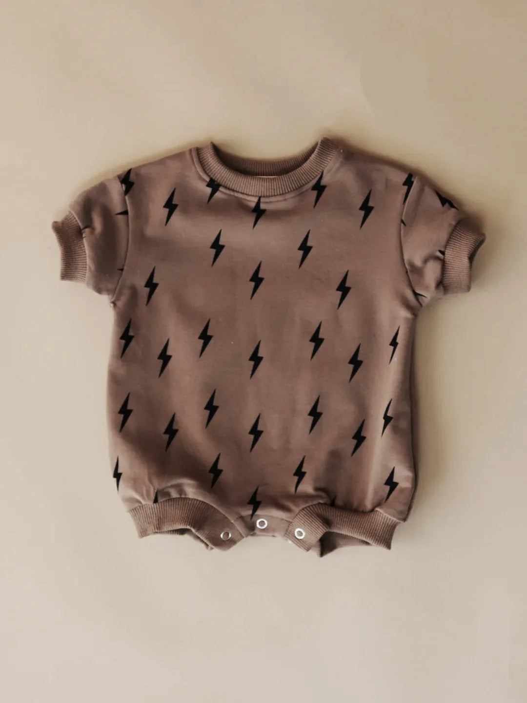 Printed triangle baby romper in cotton wool pull frame fabric with long sleeves and ribbed hem