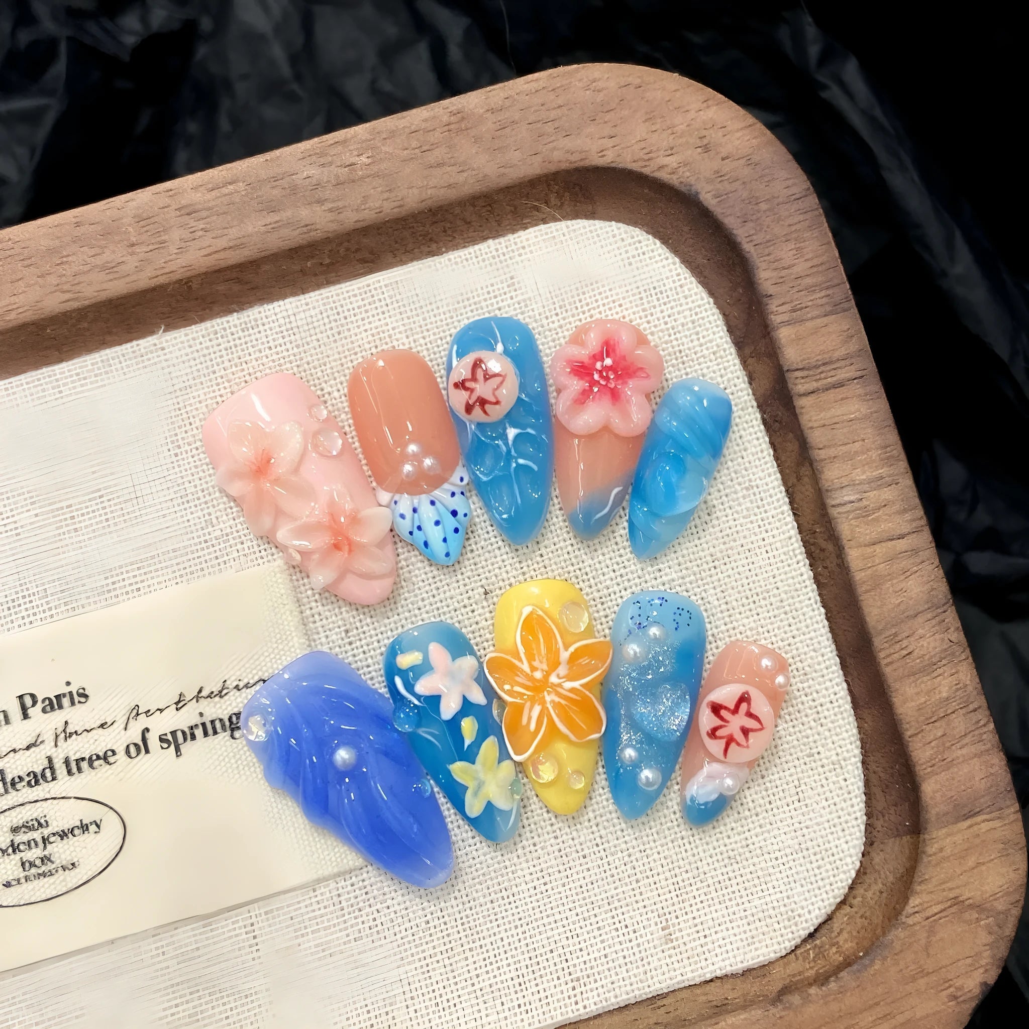 Three-dimensional carved plastic jellyfish wearable armour in almond nail colour for cosplay.