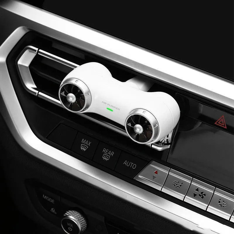 Compact black or white car air purifier with anion and aromatherapy functions for vehicle use.
