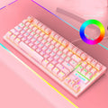 Black mechanical gaming keyboard with coloured keycaps and simple design next to notebook computer