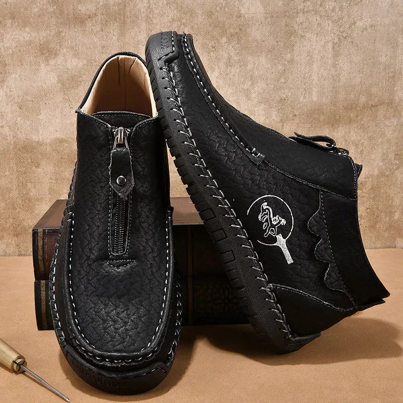 Men's black slip-on loafers with round toe and stitched sole on a plain background
