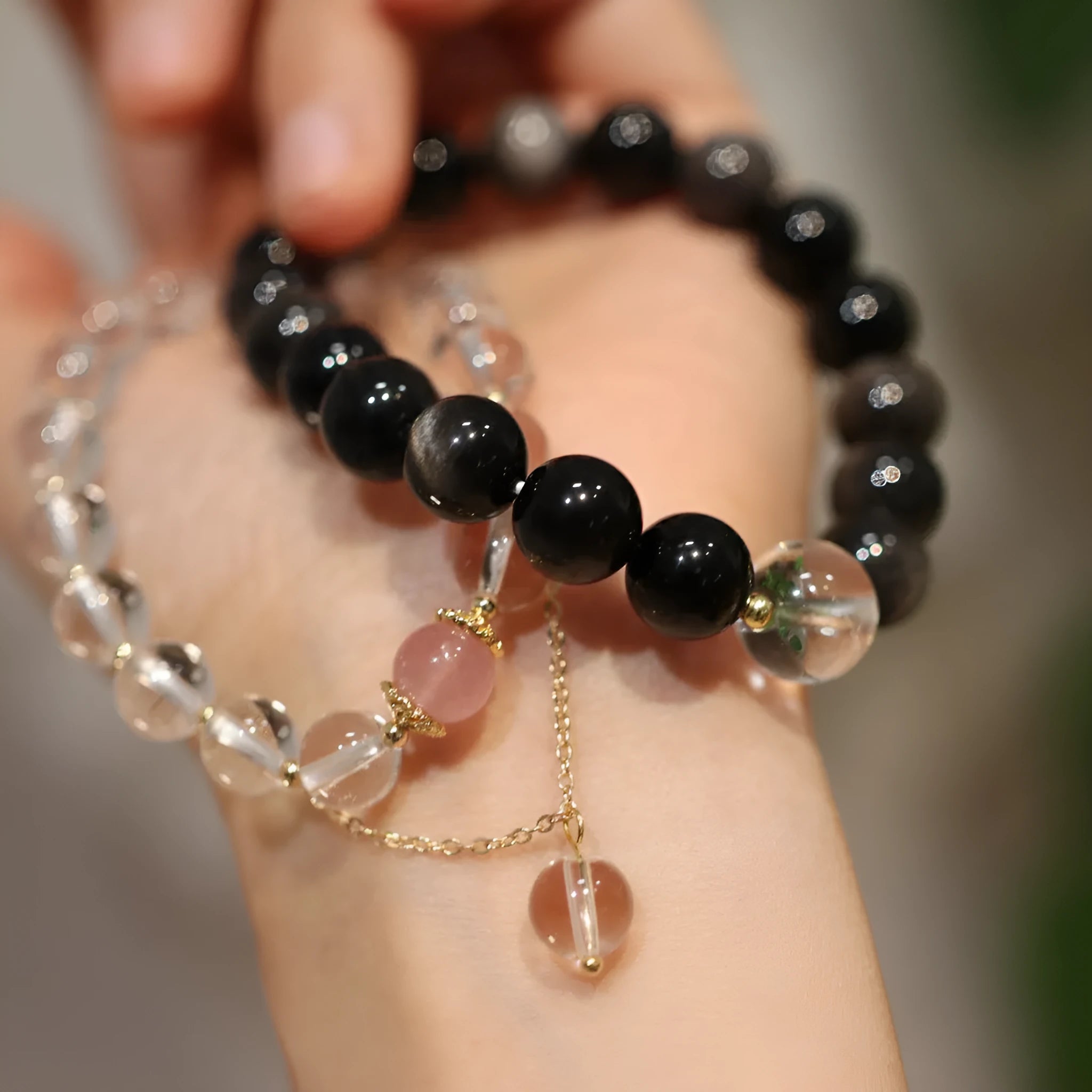 White and pink crystal bracelet with cat eye obsidian accents in Chinese geometric style
