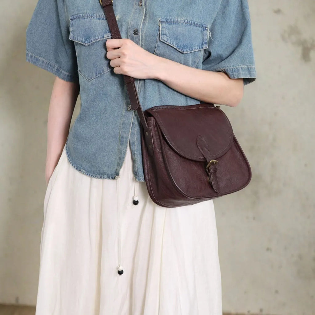 Brown genuine cowhide leather retro messenger bag with flap closure and crossbody strap
