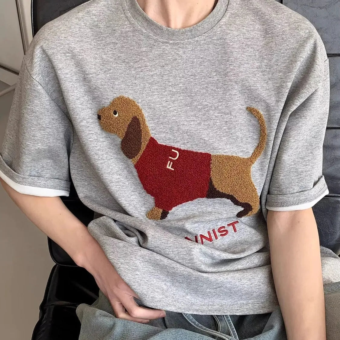 Men's grey cotton T-shirt with an embroidered brown sausage dog design on the front.