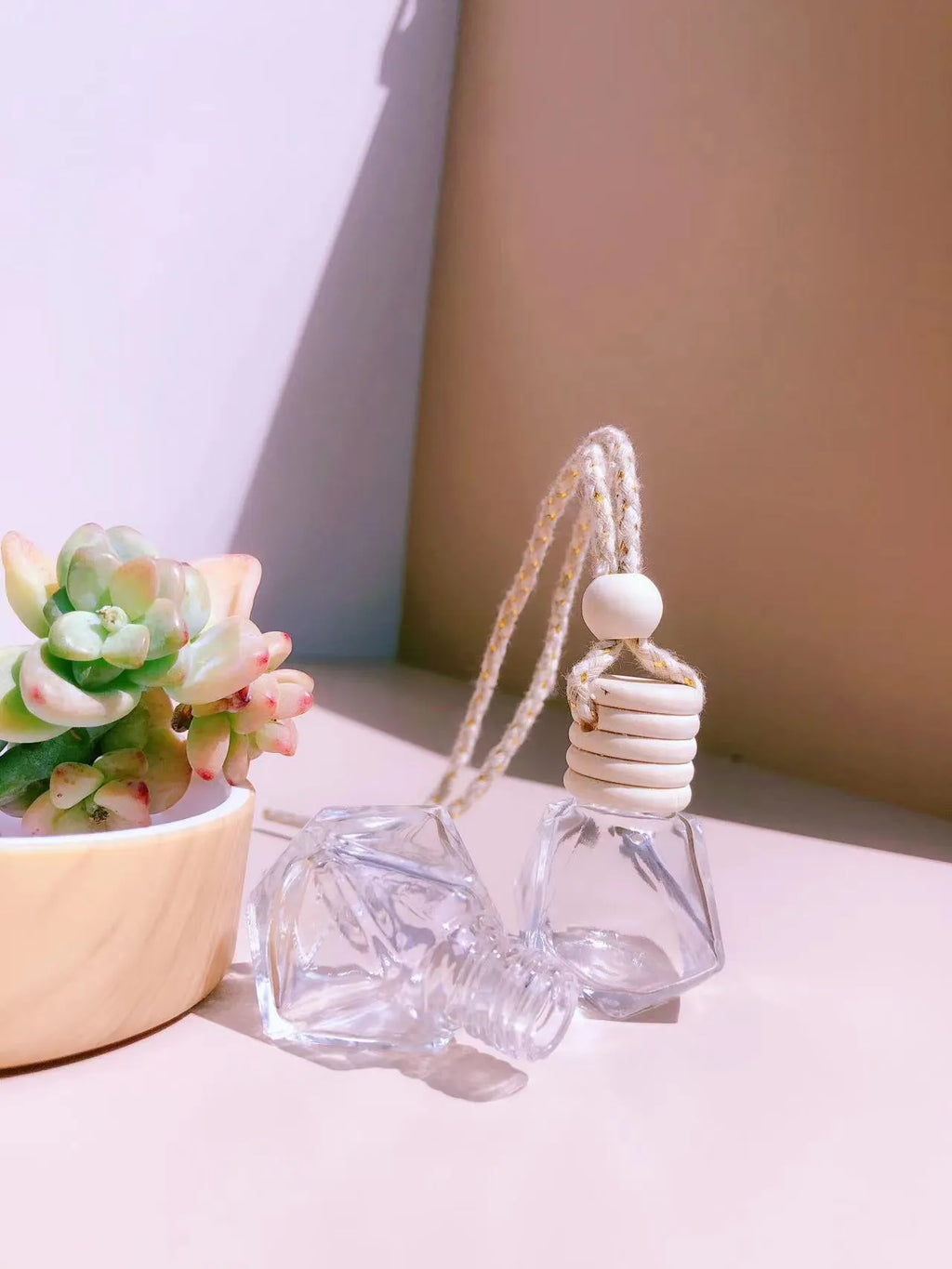Glass car perfume pendant fragrance diffuser in cylinder, diamond, flat drum, and square styles.