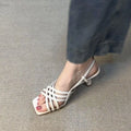 Women's beige retro sandals with thin cross-straps, an ankle buckle, and a 3-6cm mid-heel on a square toe.
