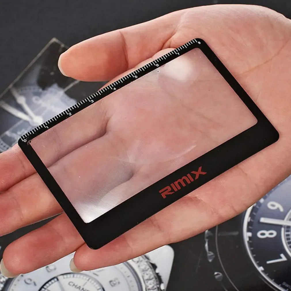 Portable black and white plastic card magnifier for close-up reading.