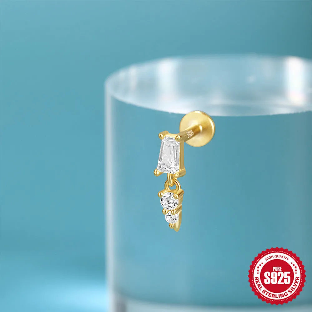 Sterling silver ear stud with a hanging gold-tone tassel charm on a white background.