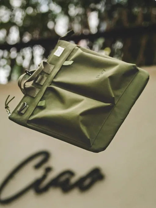 Medium canvas crossbody messenger bag in military green colour with laptop compartment and phone pocket