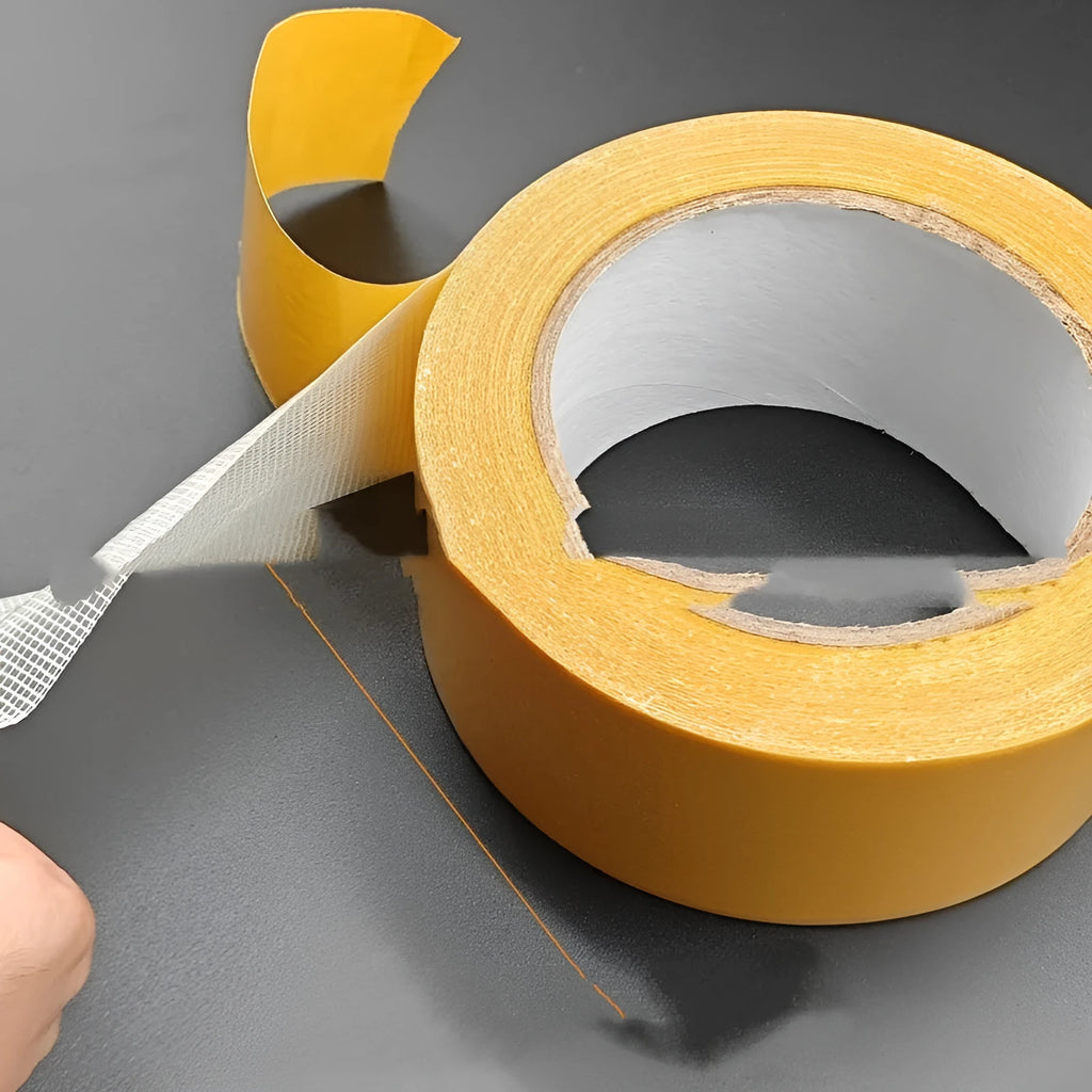 Roll of yellow grid double-sided cloth tape 5cm wide 20m long on white background