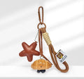 Handmade soda bread handbag pendant with baking varnish treatment showing five creative designs