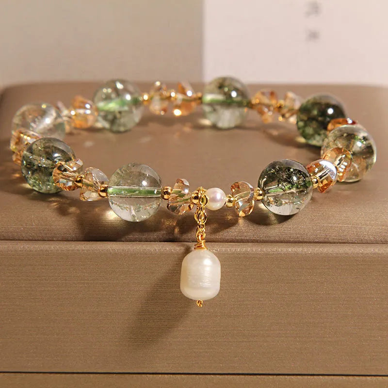 Adjustable green phantom quartz and champagne crystal bead bracelet on a string cord.