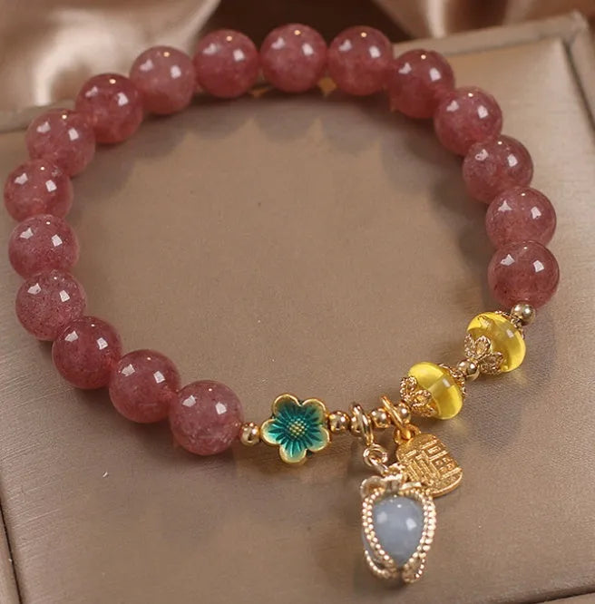 Red women's beaded bracelet with a strawberry quartz centre stone and sparkling rhinestones on an alloy chain.